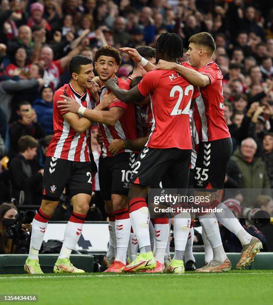 Che Adams of Southampton celebrates with teammates after scoring their team's first goal during the Premier League match between Norwich City and...