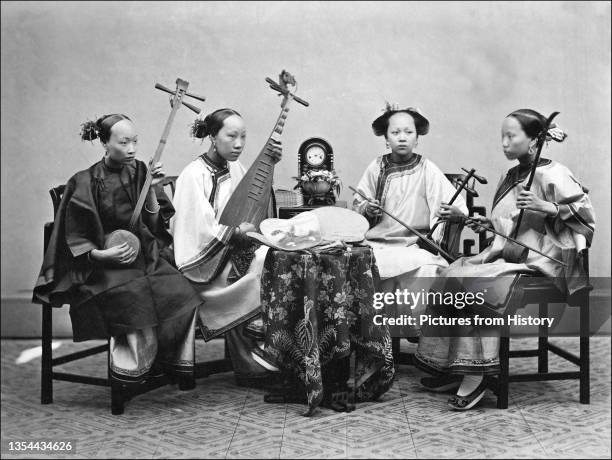 Four Chinese female musicians playing from left to right; a sanxian, a pipa, an erxian and an erhu.