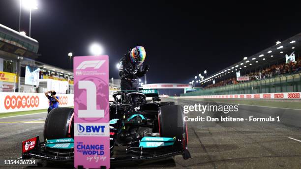 Pole position qualifier Lewis Hamilton of Great Britain and Mercedes GP celebrates in parc ferme during qualifying ahead of the F1 Grand Prix of...