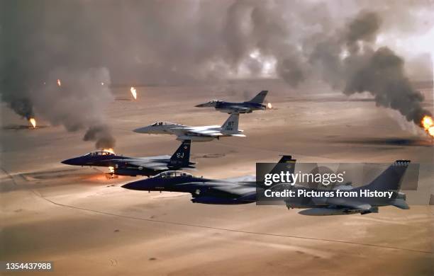 Aircraft of the 4th Fighter Wing fly over Kuwaiti oil fires, set by the retreating Iraqi army during Operation Desert Storm in 1991. The Persian Gulf...