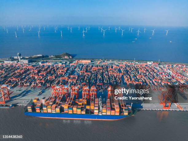 morden shanghai yangshan deep water container port and large scale of wind turbines farm on the sea - air freight transportation stock pictures, royalty-free photos & images