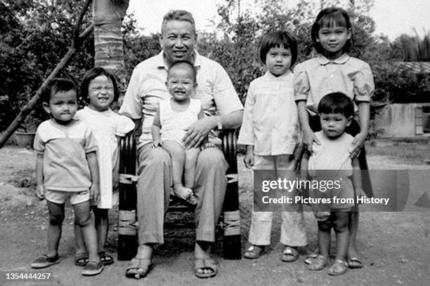 Khmer Rouge leader Saloth Sar, aka Pol Pot, sitting with group of children at Anlong Veng c1990. The child on his lap is probably Pol Pot's daughter....
