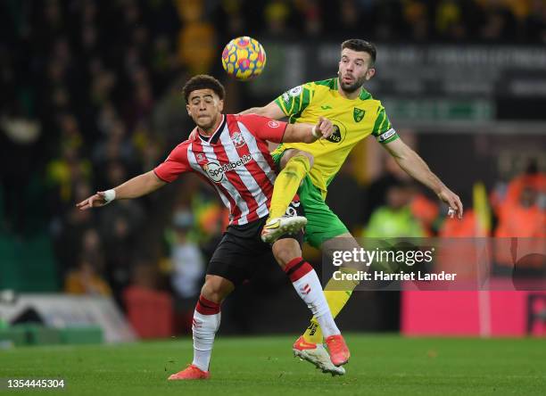 Che Adams of Southampton battles for possession with Grant Hanley of Norwich City during the Premier League match between Norwich City and...