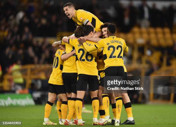 Raul Jimenez of Wolverhampton Wanderers celebrates with teammates after scoring their team's first goal during the Premier League match between...