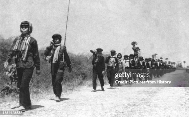 Khmer Rouge women's batallion on the march, c.1974-1975. This image was used on the Khmer Rouge currency notes printed in China in 1975 but never...