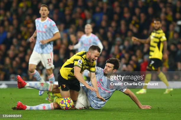 Tom Cleverley of Watford FC is fouled by Harry Maguire of Manchester United leading to a second yellow card and red card during the Premier League...