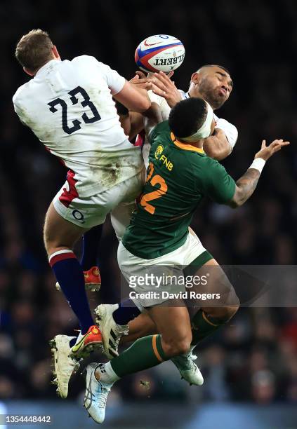 Elton Jantjies of South Africa contests a high ball with Max Malins and Joe Marchant of England during the Autumn Nations Series match between...