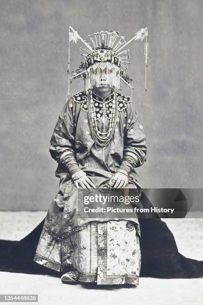 This photograph shows a Chinese bride in Batavia in her wedding dress. The commercial development of Batavia under the Dutch created numerous...