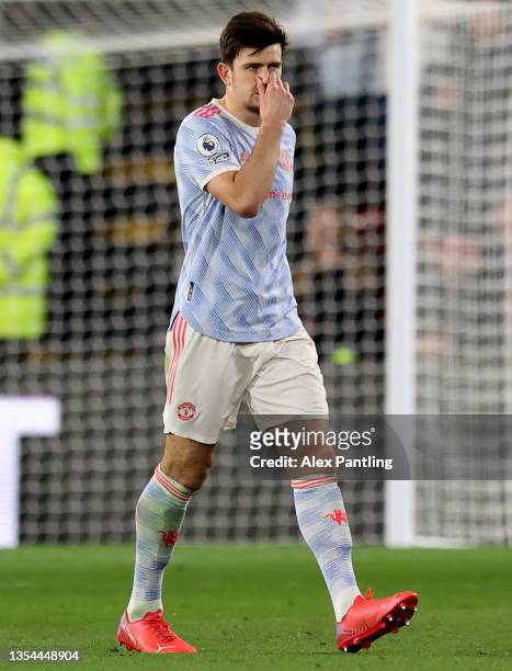 Harry Maguire of Manchester United looks dejected after being sent off during the Premier League match between Watford and Manchester United at...