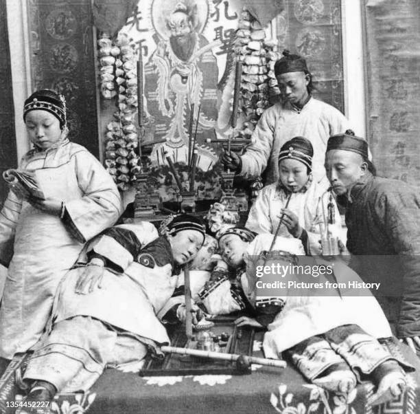 Studio opium typfying a contemporaneous Occidental view of China, including opium smoking and young 'singsong' girls with bound feet. Dated to the...