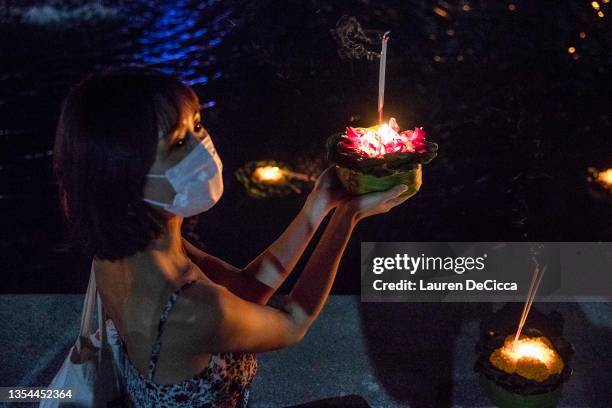 Tourists launch krathongs, floating lantern rafts, during the Yee Peng Festival on November 20, 2021 inLamphun, Thailand. The Gassan Panorama Golf...