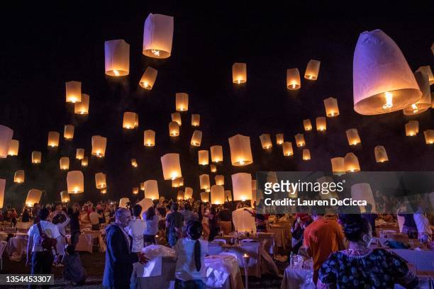 People launch 'khom loy', lanterns, into the sky during the Yee Peng Festival on November 20, 2021 inLamphun, Thailand. The Gassan Panorama Golf...