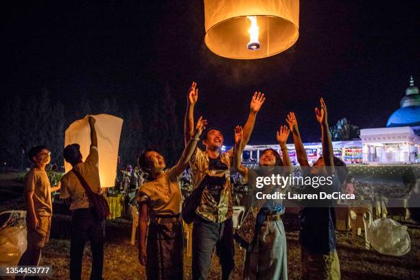Thai people launch 'khom loy', lanterns, into the sky during the Yee Peng Festival on November 20, 2021 inLamphun, Thailand. The Gassan Panorama Golf...