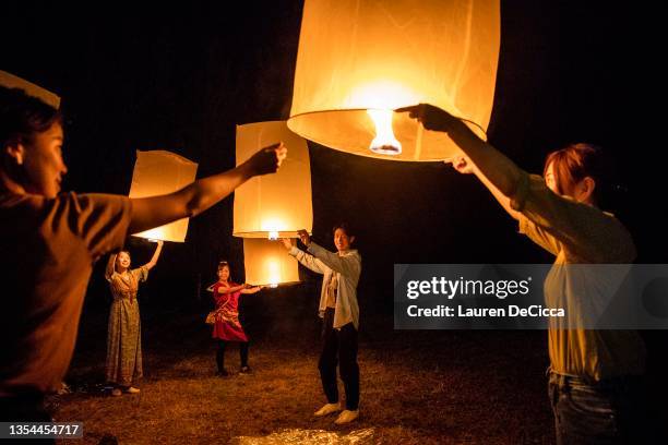 Thai people launch 'khom loy', lanterns, into the sky during the Yee Peng Festival on November 20, 2021 inLamphun, Thailand. The Gassan Panorama Golf...