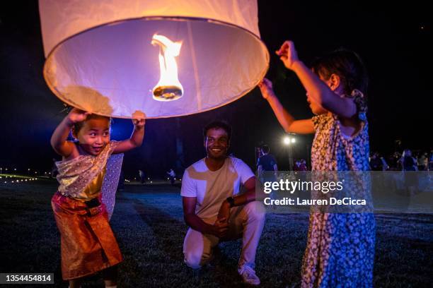 Children launch 'khom loy', lanterns, into the sky during the Yee Peng Festival on November 20, 2021 inLamphun, Thailand. The Gassan Panorama Golf...