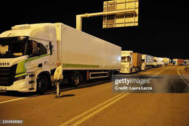 Line of trucks is seen as workers of the port of Livorno block a port access point during a strike on November 19, 2021 in Livorno, Italy. Port...