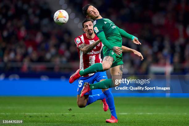 Stefan Savic of Atletico de Madrid battle for the ball with Chimy Avila of CA Osasuna during the La Liga Santander match between Club Atletico de...