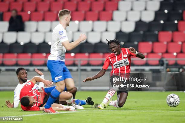 Riechedly Bazoer of Vitesse fouls Bruma of PSV during the Dutch Eredivisie match between PSV and Vitesse at the Philips Stadion on November 20, 2021...