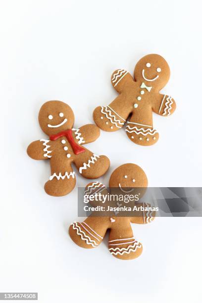 three gingerbread man  over white background - gingerbread biscuit stock pictures, royalty-free photos & images