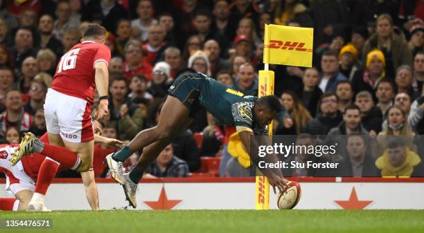 Wallabies wing Filipo Daugunu dives over to score a try in the corner during the Autumn Nations Series match between Wales and Australia at...