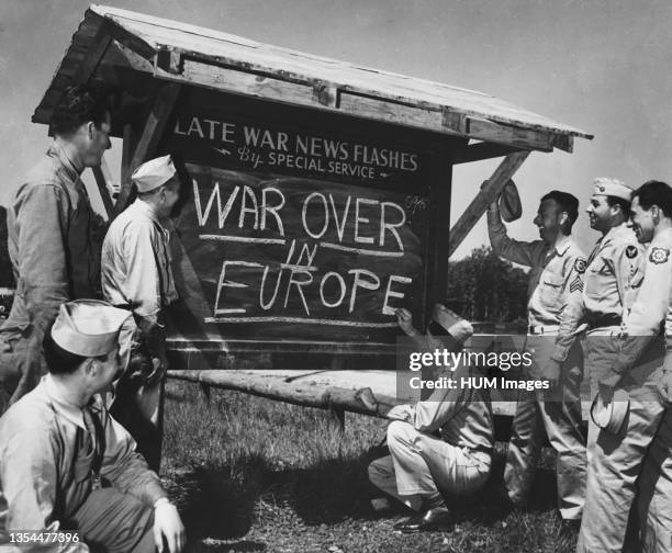 An Army private is shown breaking the news of the end of the war in Europe to other Soldiers after receiving an Associated Press news flash - circa...