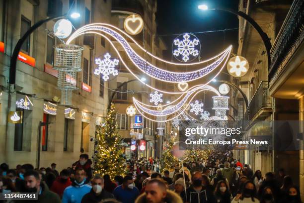 People wait for the Christmas lights to be switched on on November 20 in Vigo, Pontevedra, Galicia, Spain. The city has a big Ferris wheel and a...