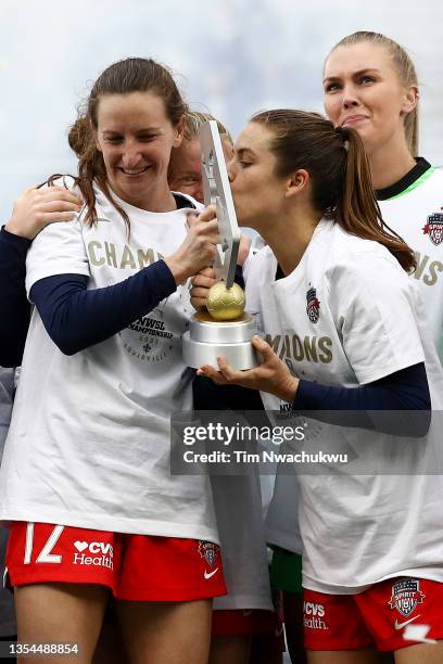 Andi Sullivan and Kelley O'Hara of Washington Spirit celebrate with the championship trophy after defeating Chicago Red Stars to win the NWSL...