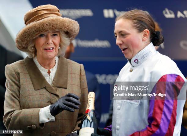 Camilla, Duchess of Cornwall presents jockey Bryony Frost with her prize after riding 'Jeremy Pass' to victory in the 'Ebony Horse Club Novices'...