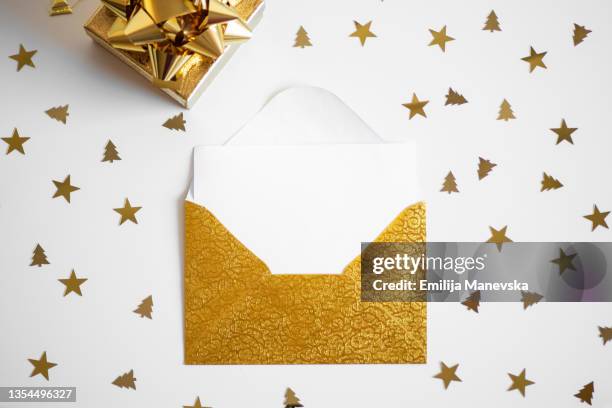 gold envelope with white paper blank card - greeting card and envelope stock pictures, royalty-free photos & images