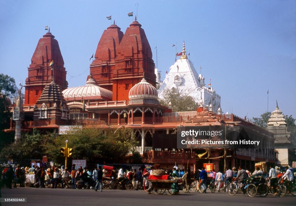 India: The red Digambara Jain Temple and white Sikh temple on busy Chandni Chowk, Old Delhi