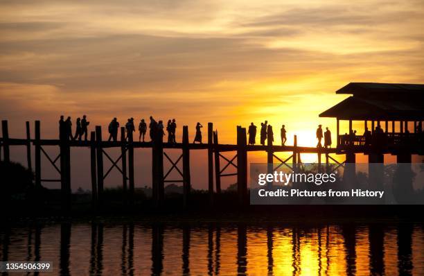 The U Bein Bridge is the longest teakwood bridge in the world and was constructed around 1850 from the abandoned teak columns of the old Ava Palace.