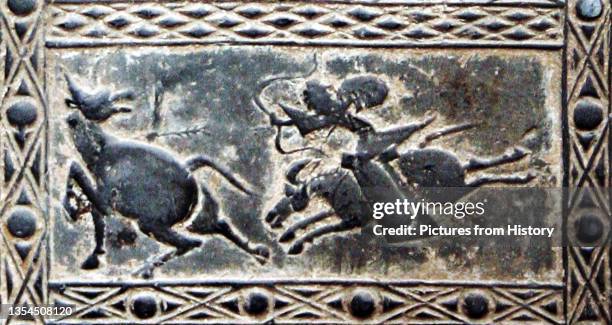 Pottery tile of the Han Dynasty, depicting hunting and battle scenes containing emblematic figures of the 'five cardinal directions' . The Four...