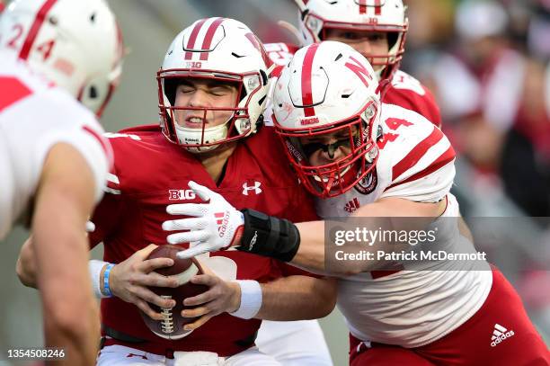 Graham Mertz of the Wisconsin Badgers is sacked by Garrett Nelson of the Nebraska Cornhuskers in the first half at Camp Randall Stadium on November...