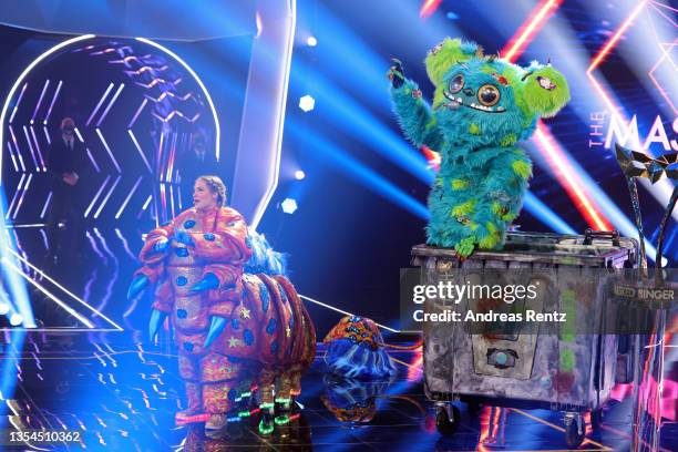 Sandy Moelling is revealed to be "Die Raupe" while winner "Muelli Mueller" watches during the final show of the 5th season of "The Masked Singer" at...