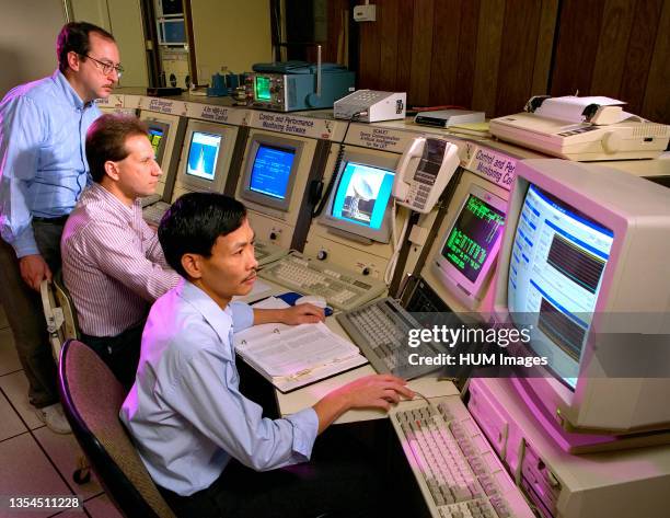Workers at NASA's Lewis Research Center - viewing information on computer monitors in 1996.