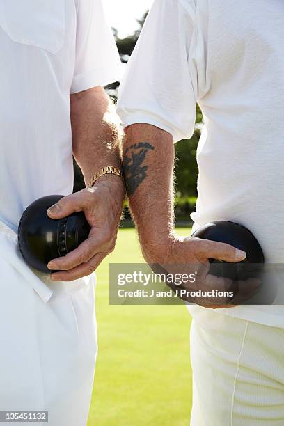 hands holding bowls - bowling green stock pictures, royalty-free photos & images