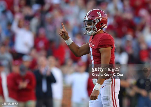 Bryce Young of the Alabama Crimson Tide reacts after passing a touchdown to John Metchie III against the Arkansas Razorbacks during the first half at...