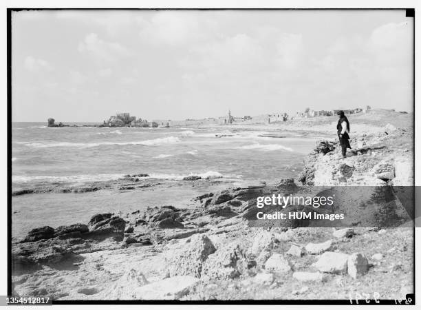 Man standing on shore looking out at the seat in Caesarea ca. 1938.