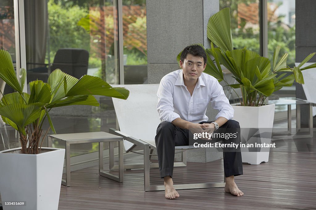 Businessman with relaxing, sitting on lounger