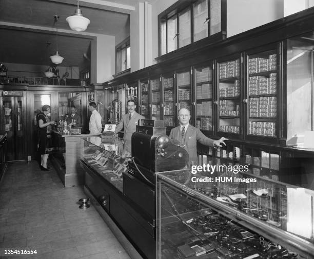 Employees behind display cases at the Offterdinger Cigar Store in Washington DC ca. Between 1910 and 1926.