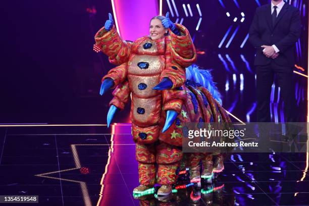 Sandy Moelling performs after being revealed to be "Die Raupe" during the final show of the 5th season of "The Masked Singer" at MMC Studios on...