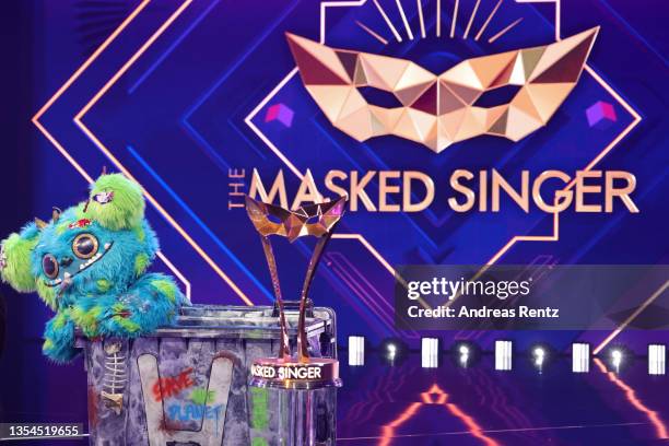 Winner "Muelli Mueller" is seen with the tropy during the final show of the 5th season of "The Masked Singer" at MMC Studios on November 20, 2021 in...