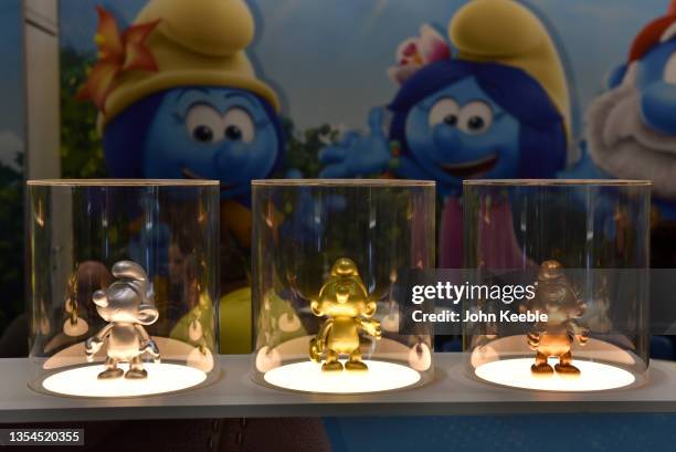 Gold, silver and bronze coloured Smurf model figures are displayed at the Smurfs stand during Brand Licensing Europe at ExCel on November 18, 2021 in...