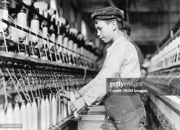 Doffer boy in Globe Cotton Mills, Augusta, Ga. Ca. 1909.