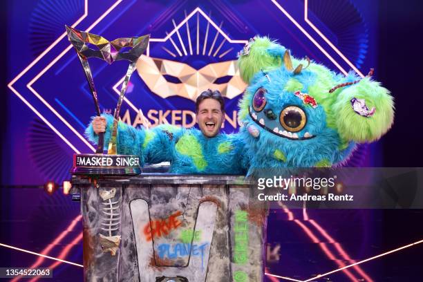 Winner Alexander Klaws aka "Muelli Mueller" poses with his trophy during the final show of the 5th season of "The Masked Singer" at MMC Studios on...