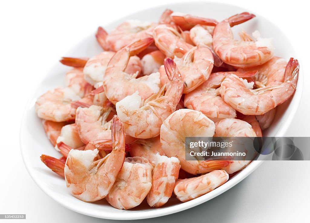 Plate of shrimps on white background