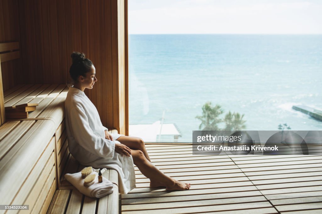 Young beautiful slim woman relaxing in spa.