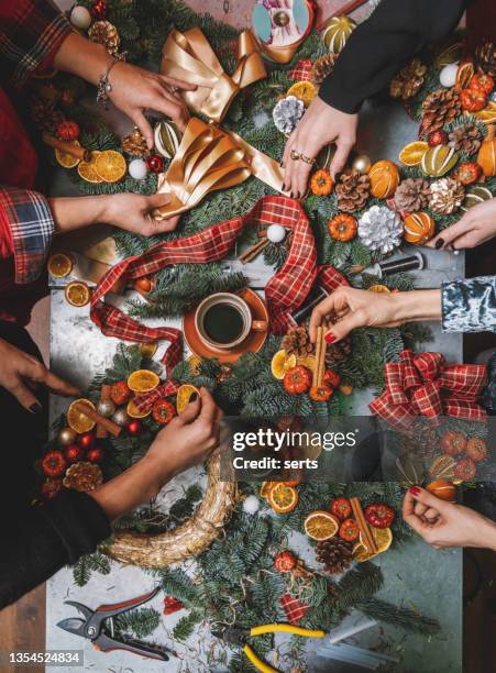 making christmas door wreath with equipments in decorator's workplace - metal flower arrangement stock pictures, royalty-free photos & images