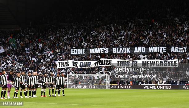 The Newcastle United team line up as fans display a welcome message to new manager, Eddie Howe, who was not able to attend after testing positive for...