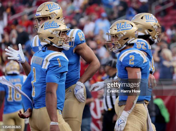 Dorian Thompson-Robinson of the UCLA Bruins celebrates the touchdown of Kyle Philips, to take a 35-17 lead over the USC Trojans, during the third...